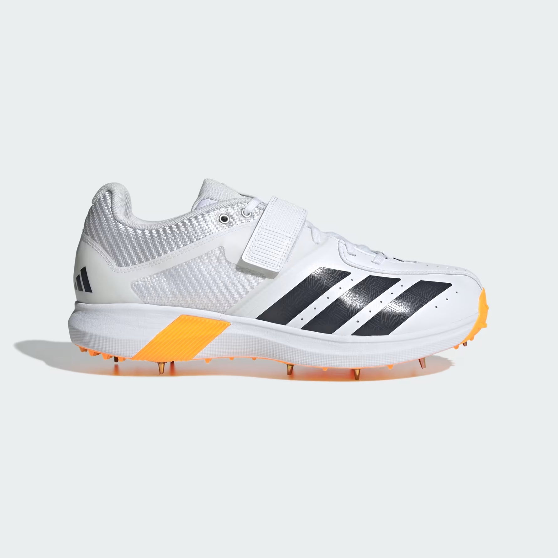 White athletic shoe with black stripes and orange sole on a light gray background